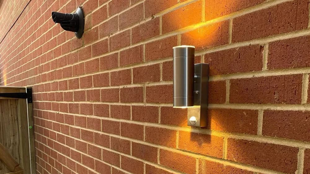 Wall-mounted exterior light on brickwork